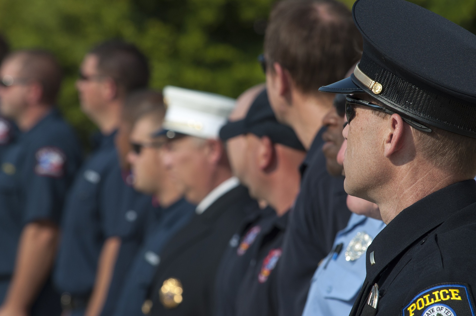 Row of police officers looking off camera.