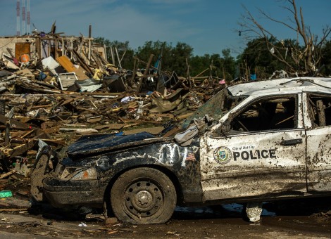 Police car severely damaged after tornado tears through the town.