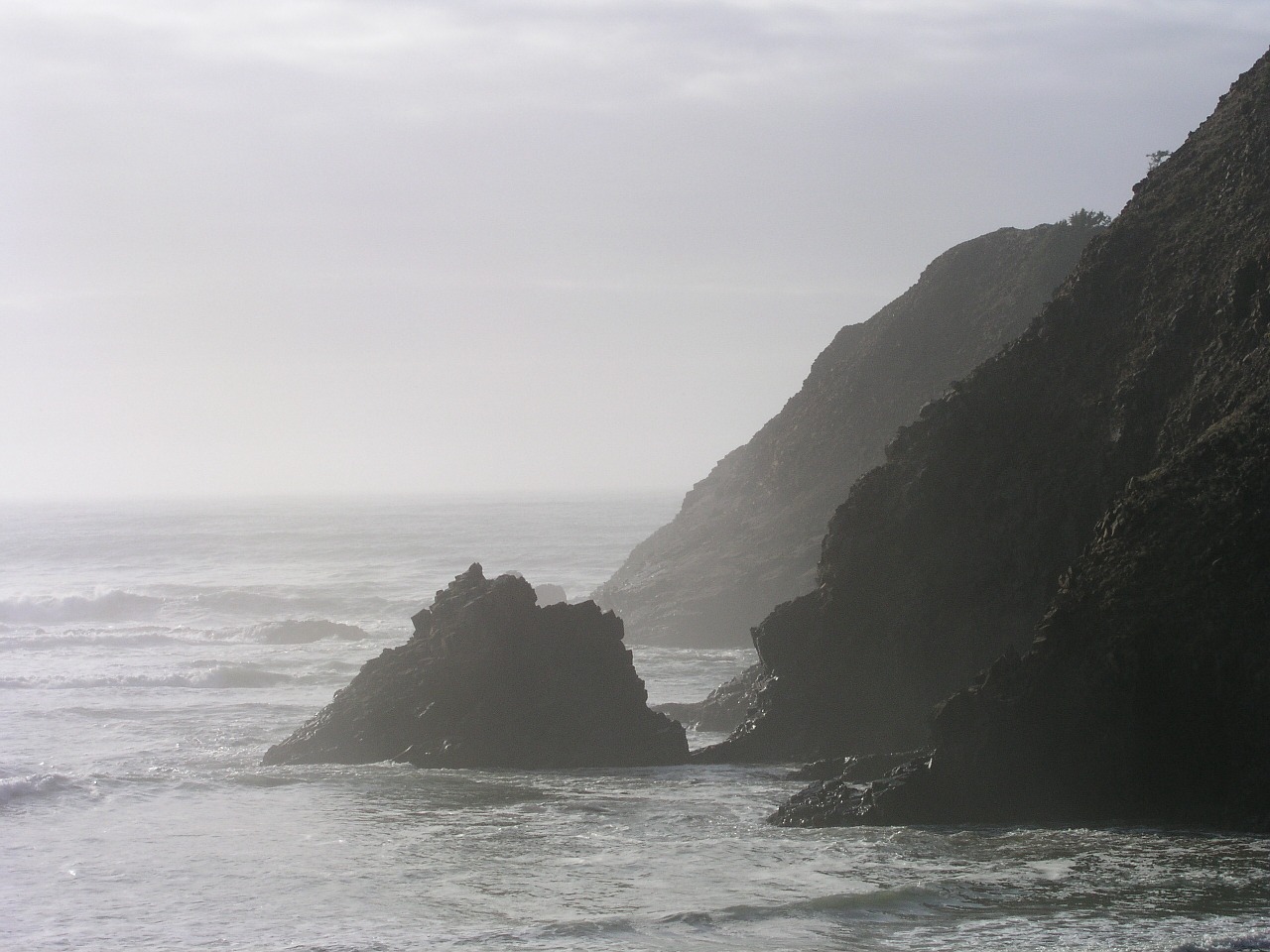 View of the Ocean with cliffs in the mist
